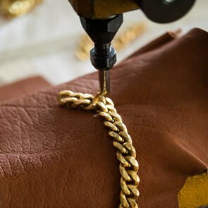 Crafting of a chain handle during the making of the Serpenti Cabochon bag, close up.