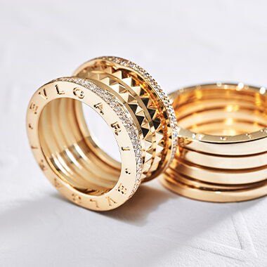 Hand wearing Bvlgari B.zero1 Rock rose gold rings with black ceramic and a B.zero1 rose gold ring with diamonds.