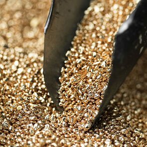 Gold grains with scoop before the casting phase, close-up. Gold grains with scoop before the casting phase, close-up.