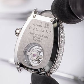 Back case of the Serpenti Seduttori Tourbillon white gold watch during the making of, close up.