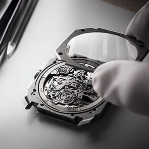 Watchmaker assembling an element of the Octo Finissimo Tourbillon Chrono Automatic watch, close-up.