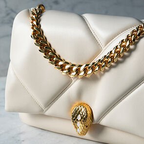 Serpenti Cabochon bag in white maxi matelassé calf leather with chain handle and snakehead closure.