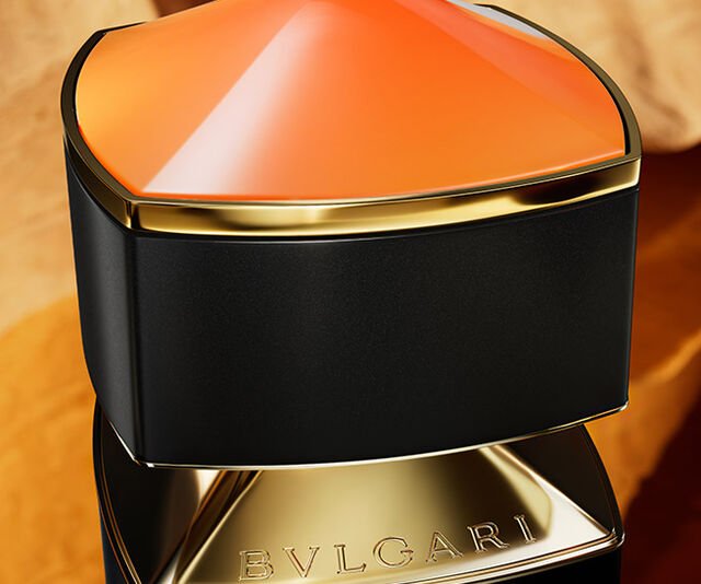 Orange cap of the Bulgari Le Gemme Ambero fragrance inspired by the amber, close up.