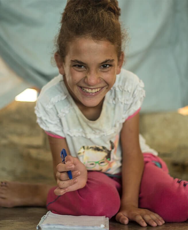 B-for-Beirut and Save the Children. Little girl with a book in her hands.