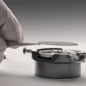 Watchmaker assembling a calibre component of the Octo Finissimo Perpetual Calendar watch, close-up.