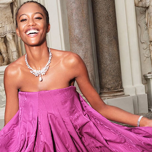Model wearing the Wings of Rome platinum necklace with diamonds from the Bvlgari Barocko High Jewellery collection, Roman background.