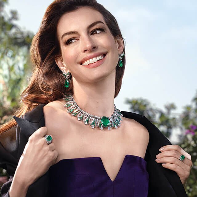 Anne Hathaway wearing Eden High Jewellery sapphire earrings and ring and a Serpenti bracelet. Anne Hathaway wearing Eden High Jewellery sapphire earrings and ring and a Serpenti bracelet.