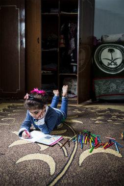 Young girl painting from the Save the Children Project