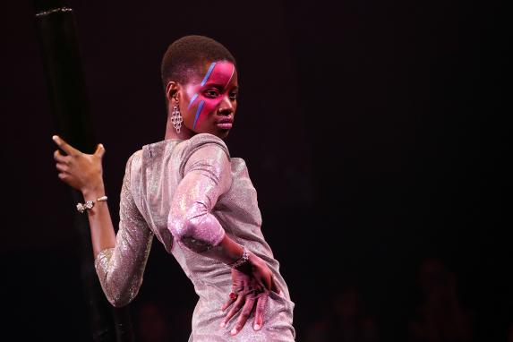A model performing with a colorful make-up