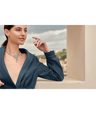 A model wearing a necklace and a ring